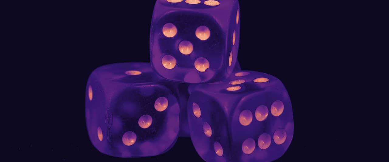 Three dice on a black surface