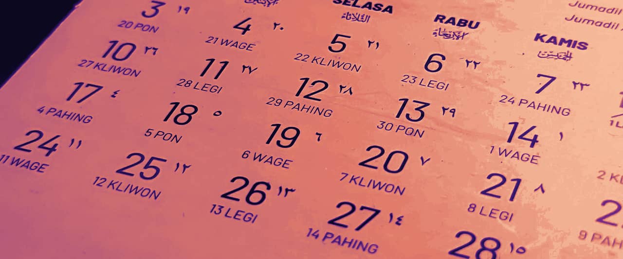 Close-up of a printed calendar page lit from the side