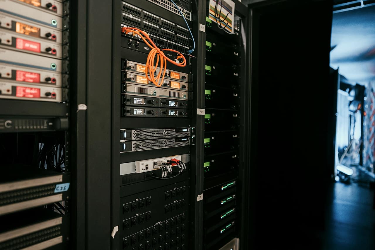 A rack of networked servers with cables in a data room