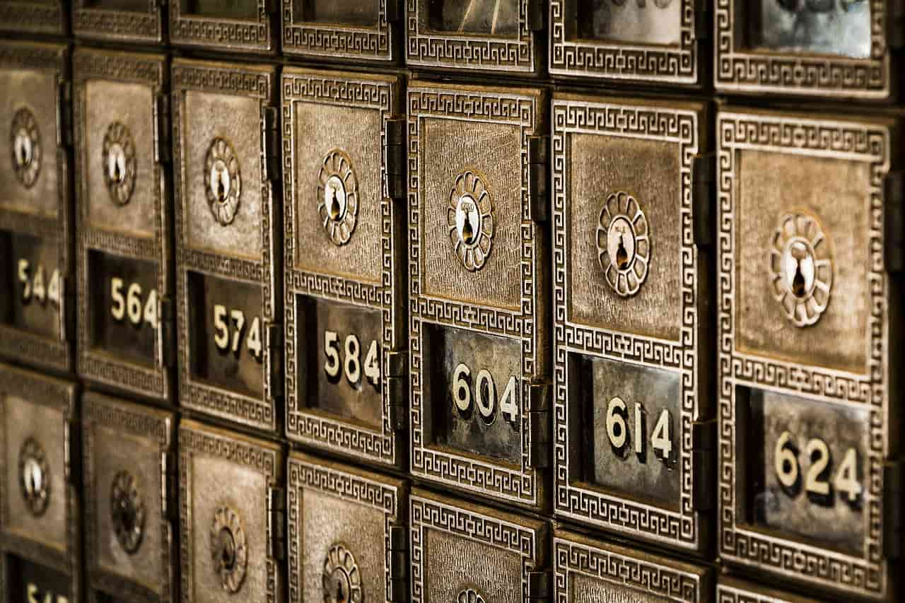 Numbered brass safe deposit boxes in a bank wall