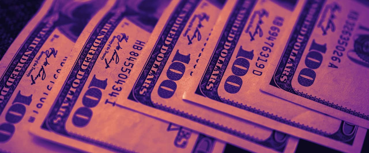 Twenty dollar bills fanned out in a loose pile