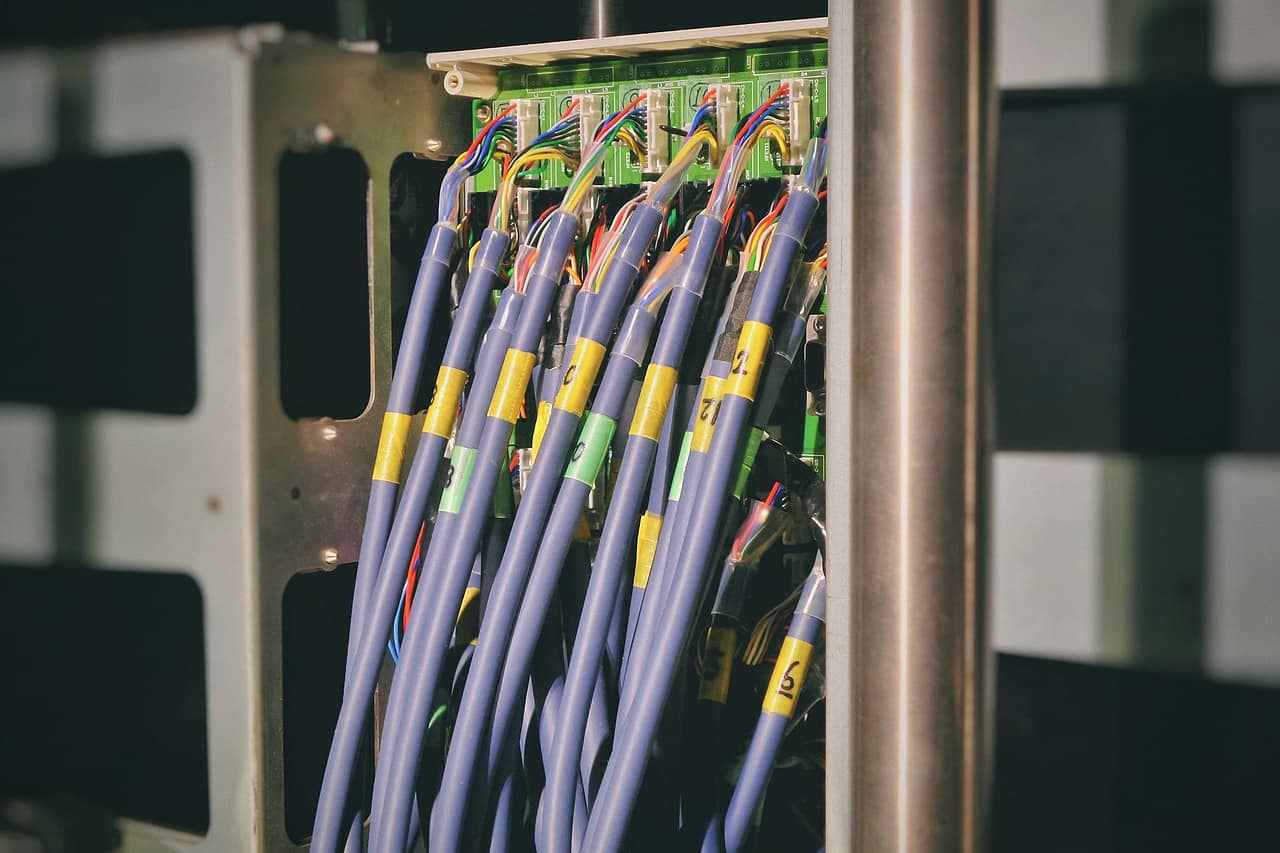 Bundles of network cables plugged into equipment in a rack