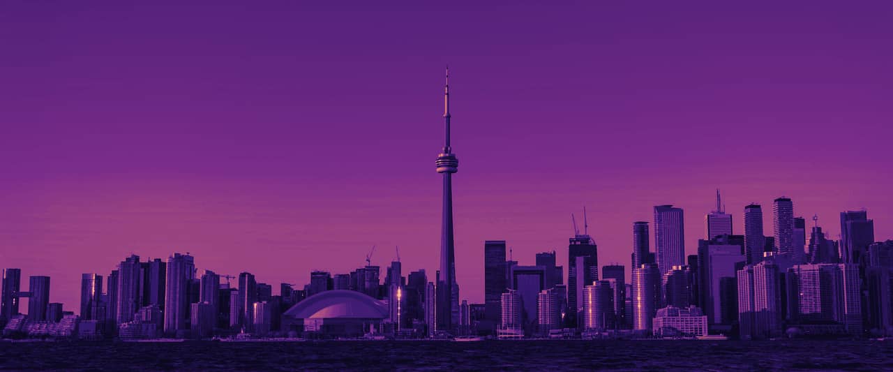 The Toronto skyline and the CN Tower seen across the water at sunset