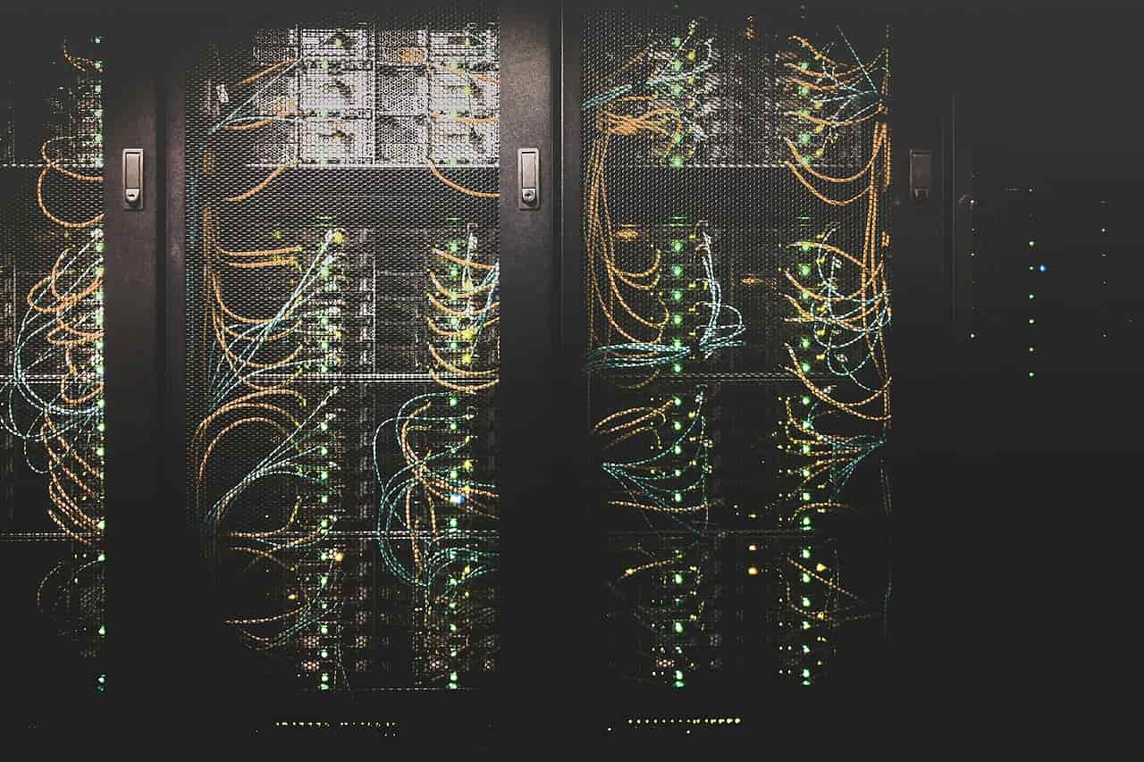 Bundles of network cables running into rows of server racks