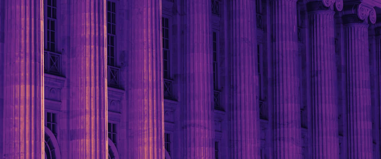 Tall fluted stone columns along the front of a large public building