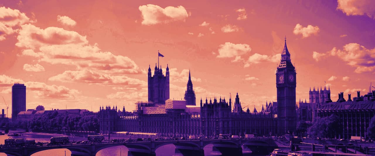 The Houses of Parliament and Elizabeth Tower beside Westminster Bridge on a bright day