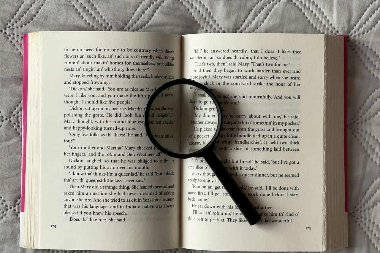 A magnifying glass resting on the pages of an open book