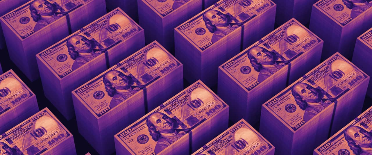Banded stacks of hundred dollar bills in neat rows