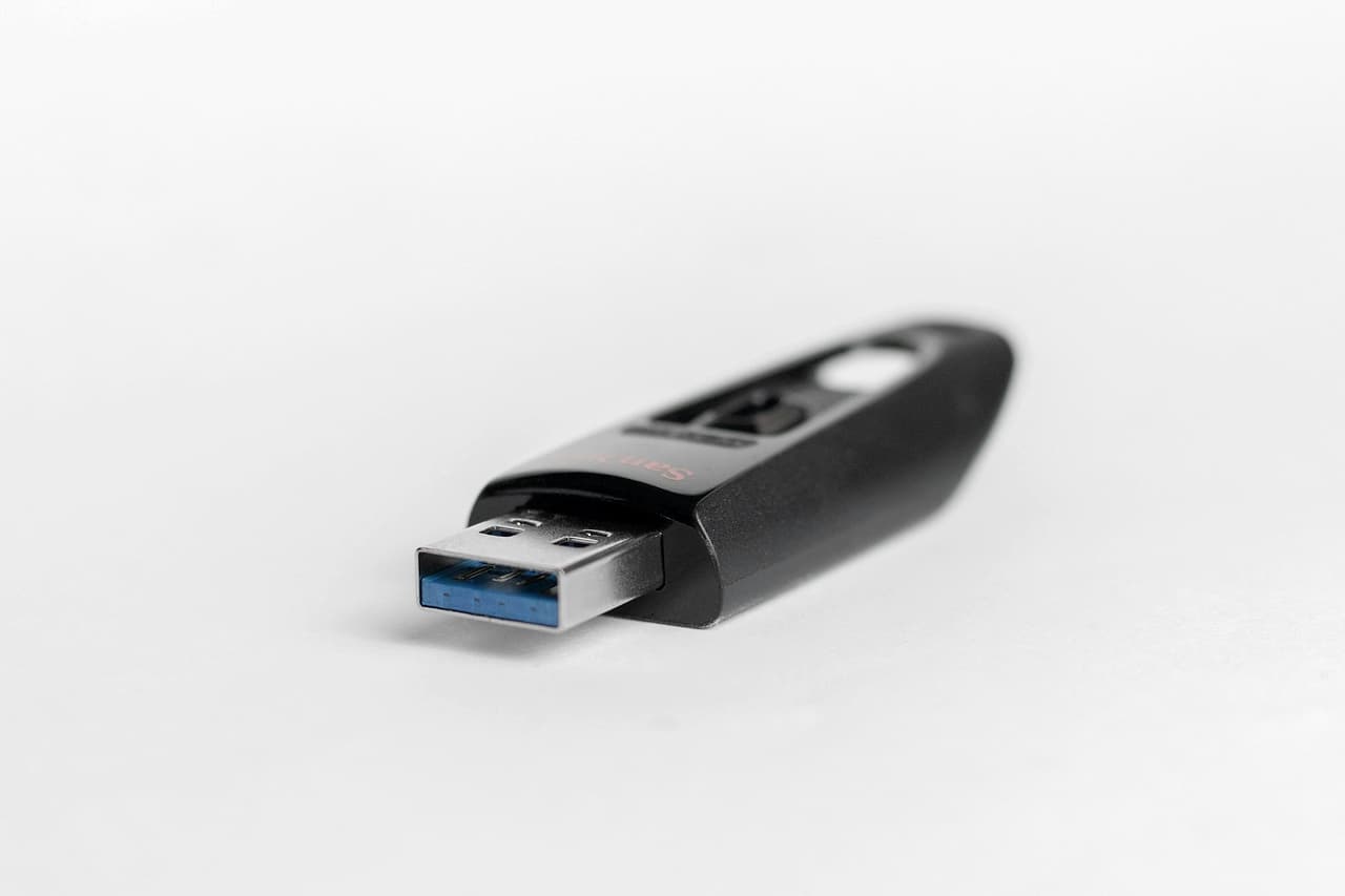 A black USB stick on a plain white surface