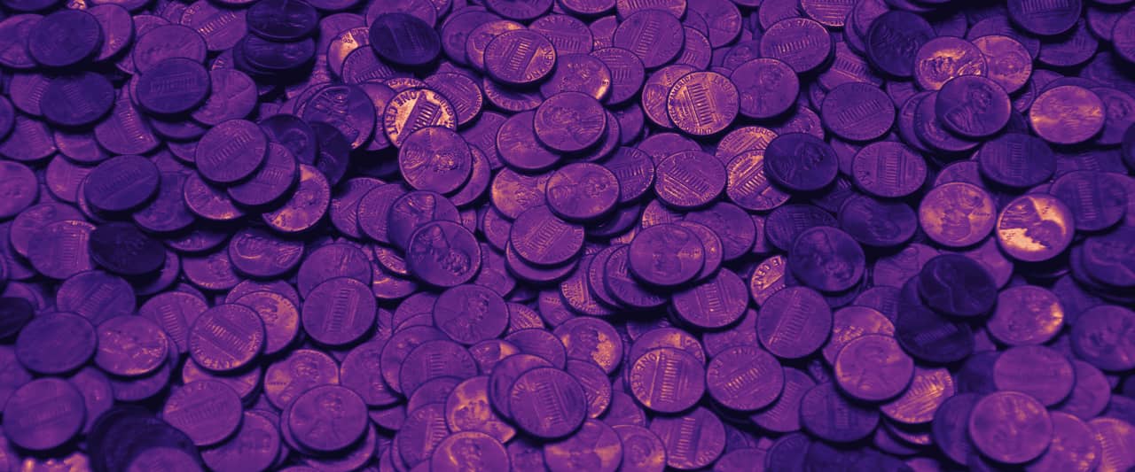 A spread of copper coins covering a wooden surface