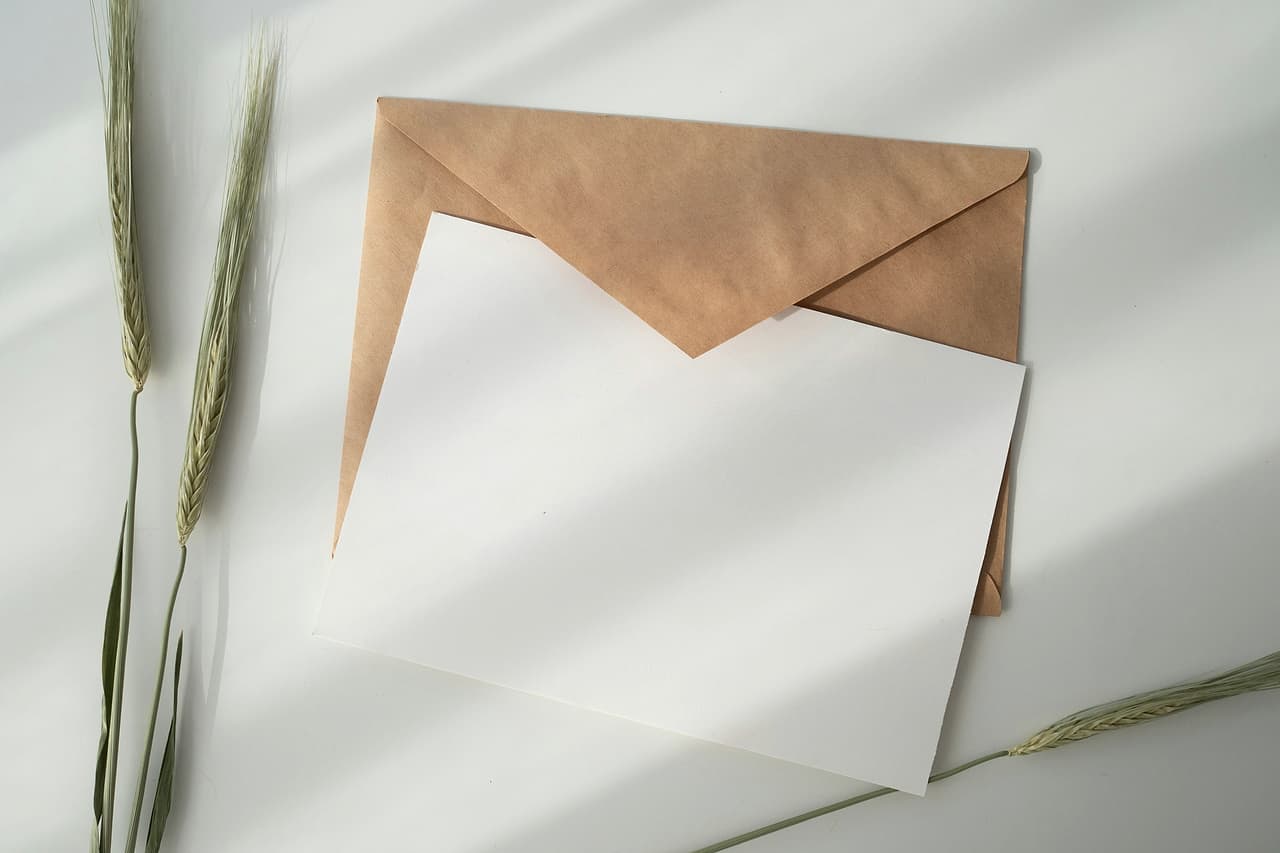 A sheet of white paper tucked into a brown envelope