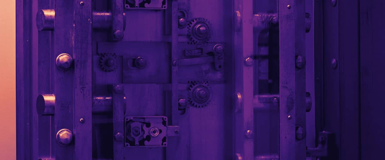 A heavy metal door with rows of bolts and handles
