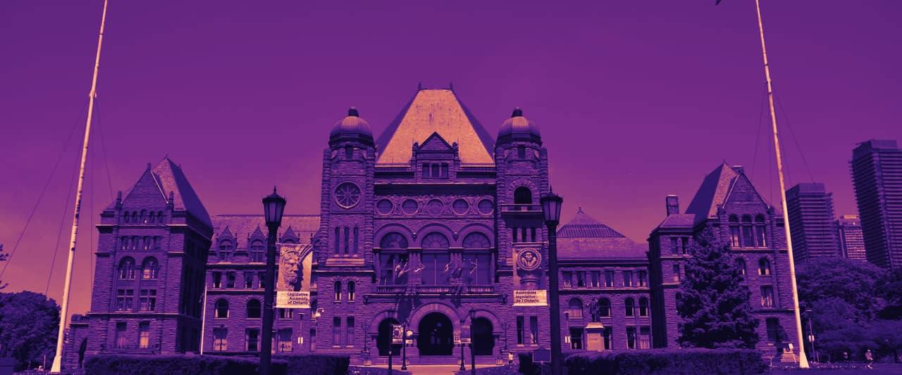 The Ontario Legislative Building at Queen's Park in Toronto with flags in front