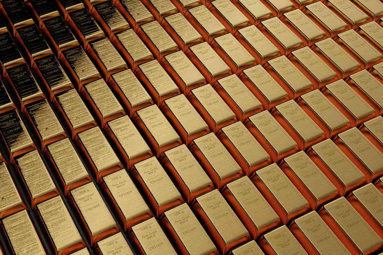 Hundreds of gold bars stacked in tight rows