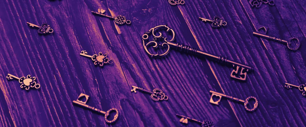 Small brass and silver keys scattered over dark wooden boards