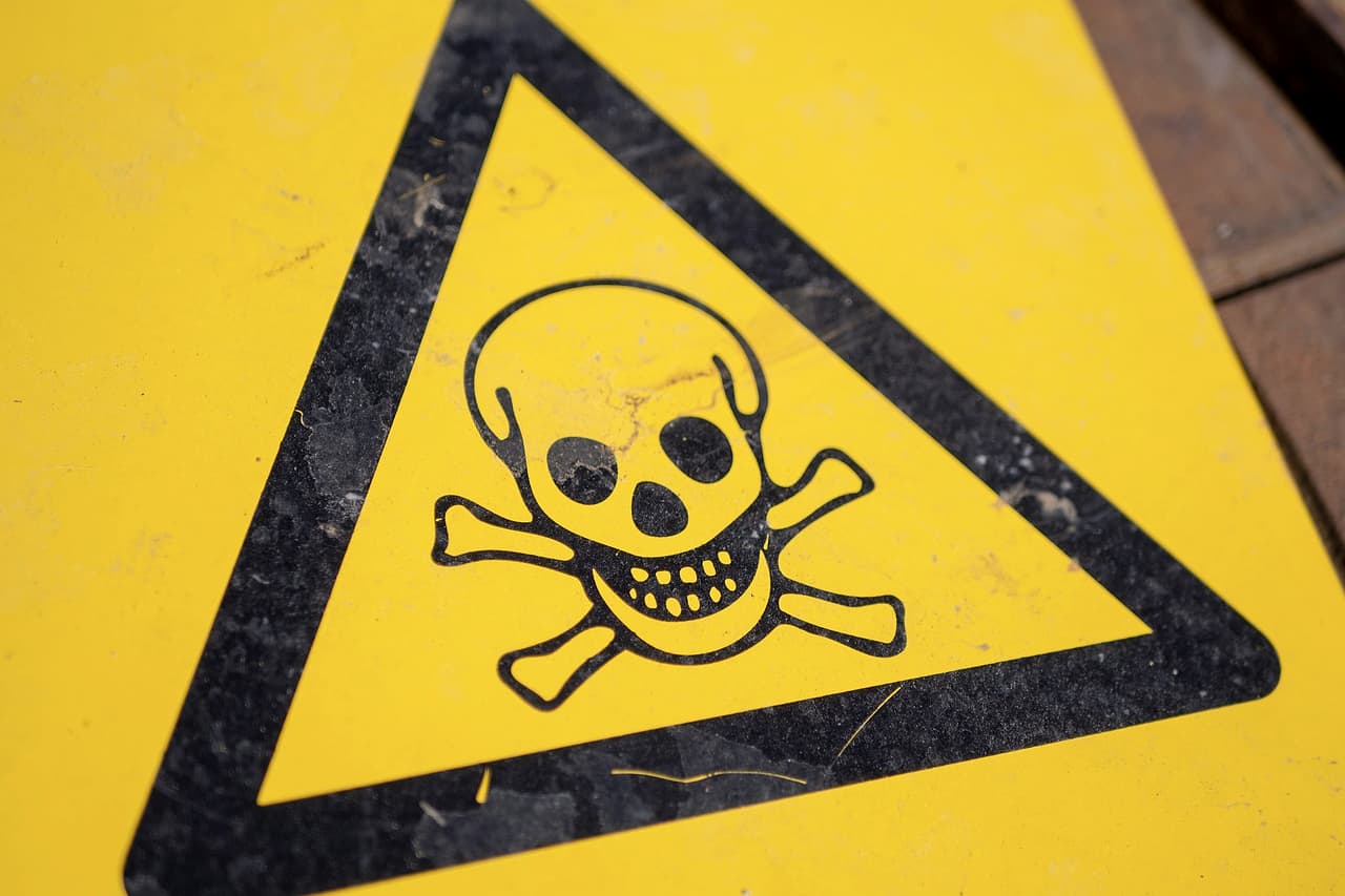 A yellow triangle warning sign with a skull and crossbones