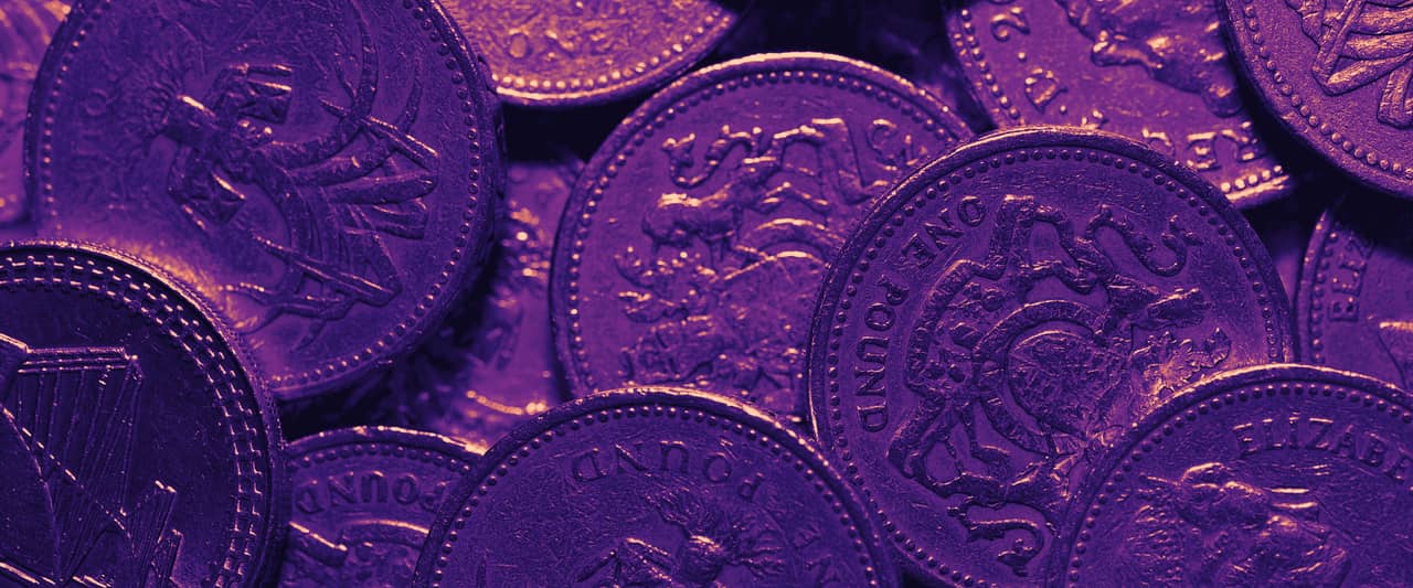 A pile of British pound coins seen from above