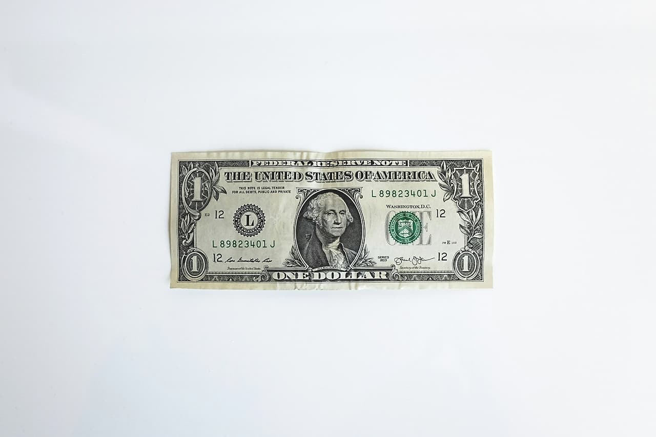 A single US one dollar bill on a white background