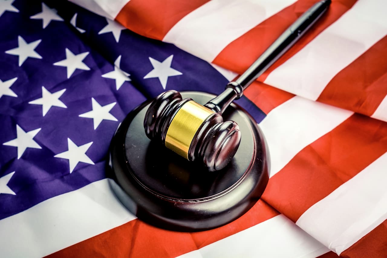 A wooden gavel resting on a United States flag