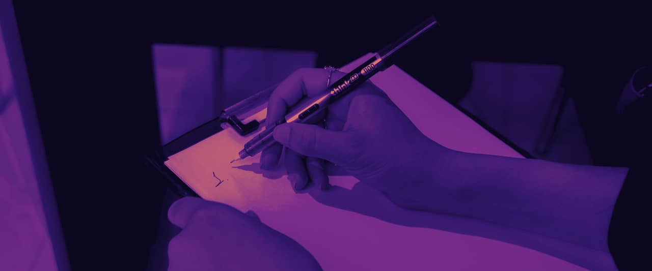 Hands writing notes with a pen on a clipboard
