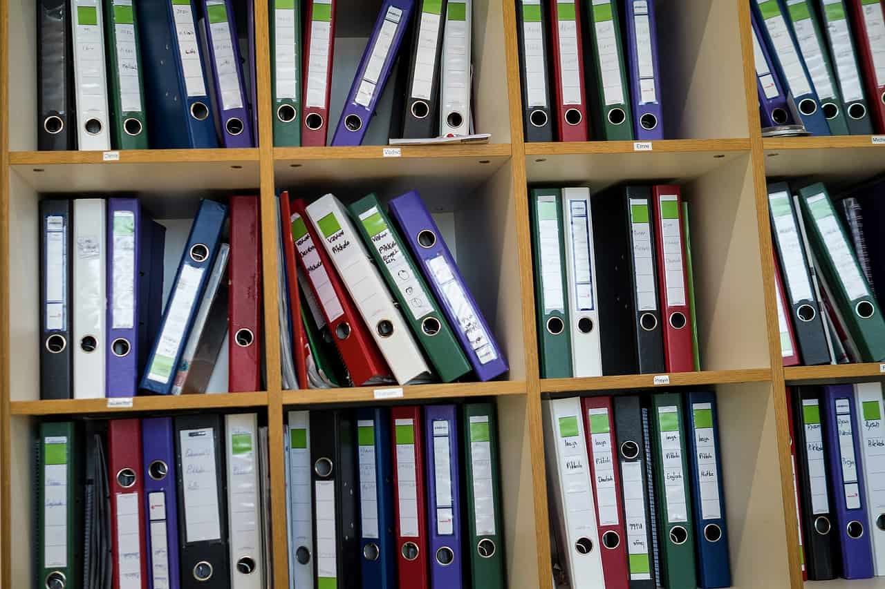 Shelves full of colourful ring binders and folders