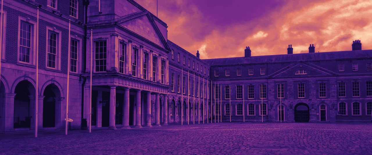 A cobbled courtyard enclosed by red brick and stone buildings in Dublin under a grey sky