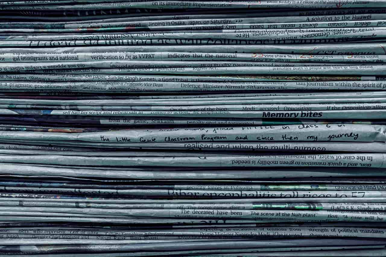 A tall stack of folded newspapers seen side on