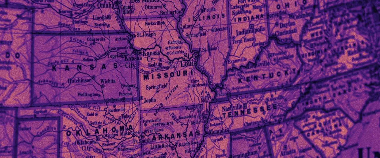 A paper road map of the central United States with state borders in red