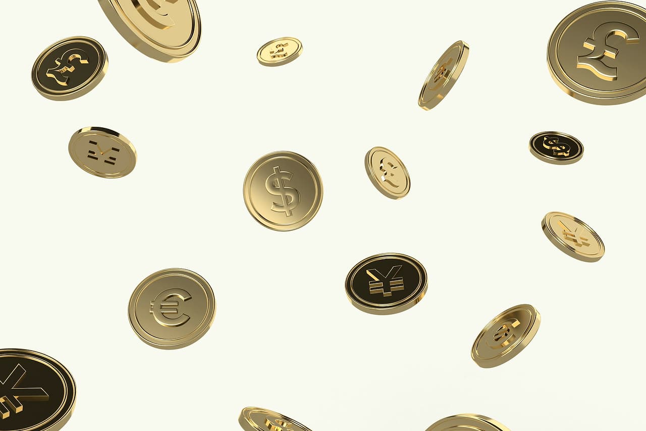 Coins tumbling through the air against a pale background