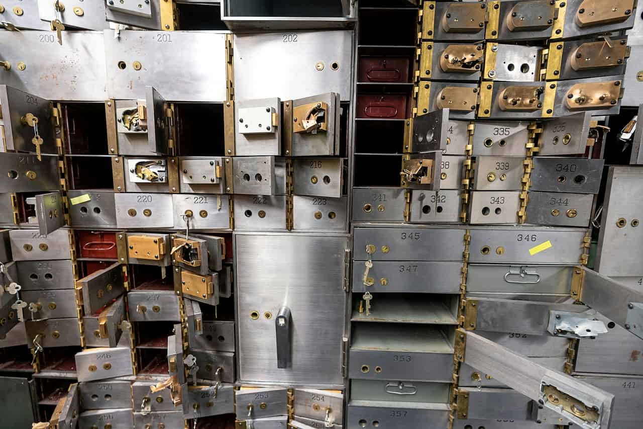 Rows of steel safe deposit drawers, some pulled open