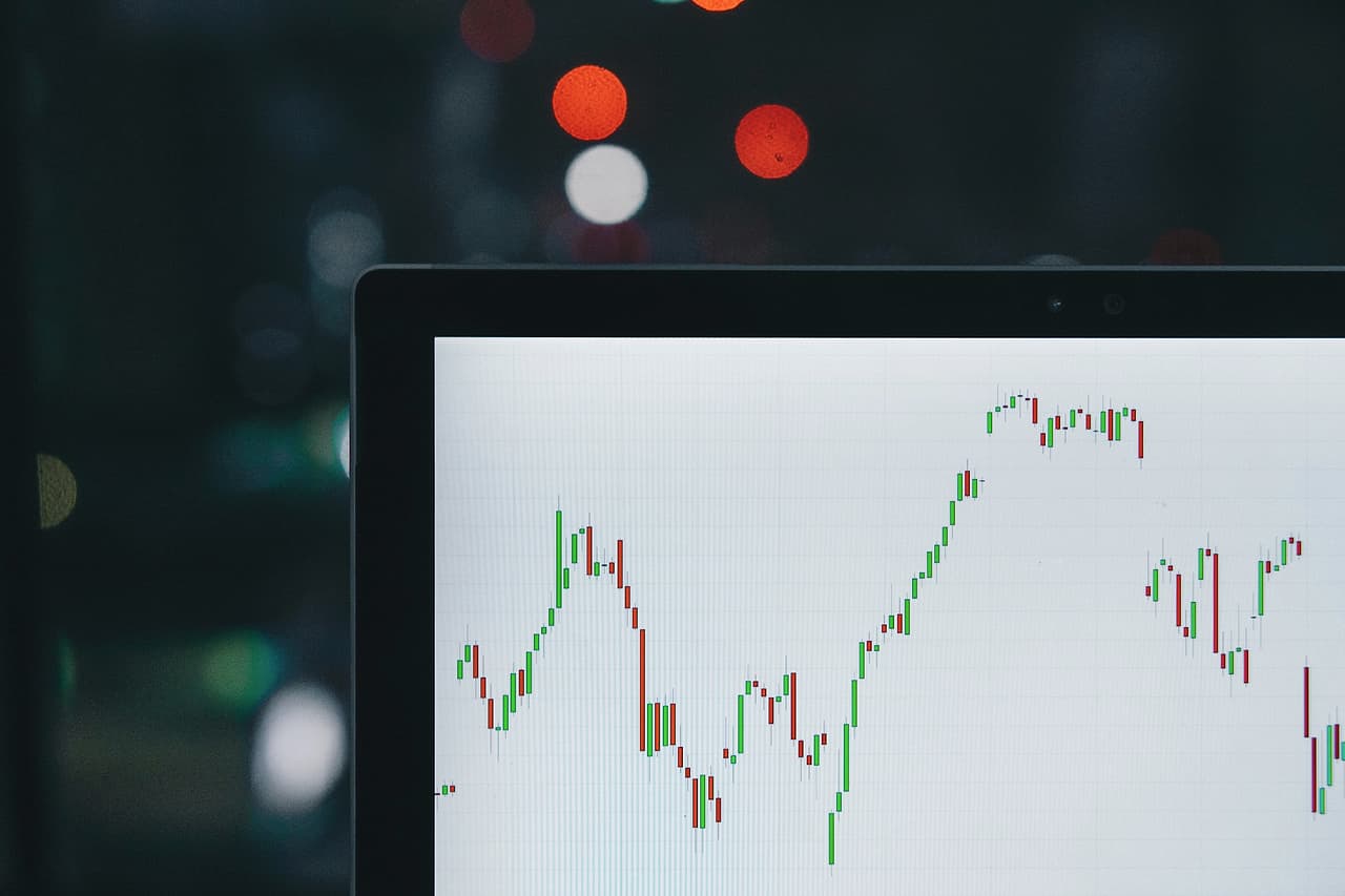 A price chart on a screen in a dim room, shot with shallow focus