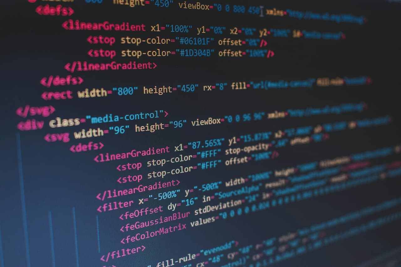 Lines of coloured code on a dark computer screen
