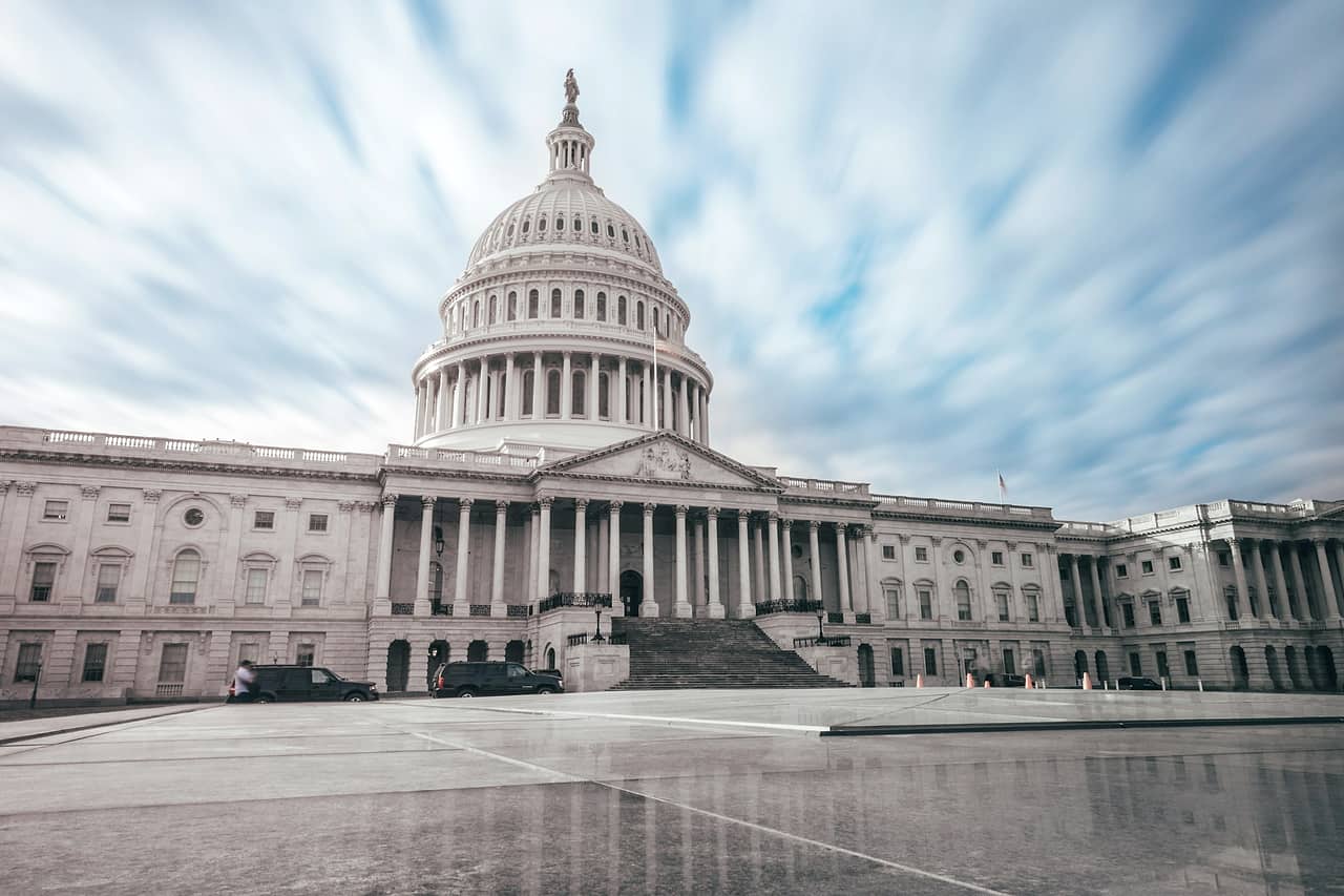 The dome of the United States Capitol under a blue sky with clouds
