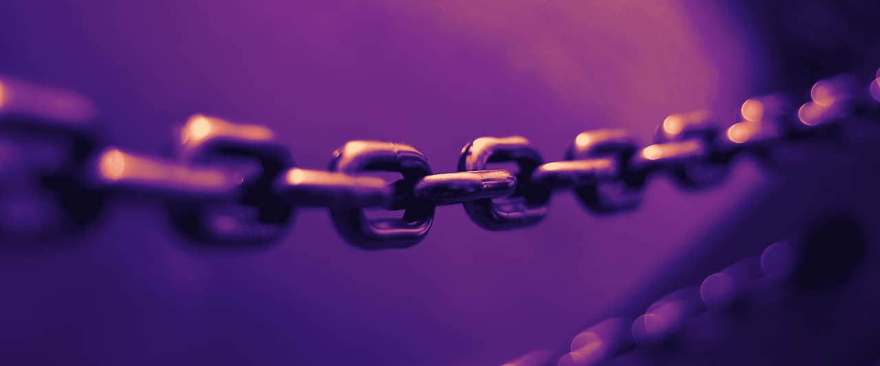 A steel chain crossing the frame against a blue background