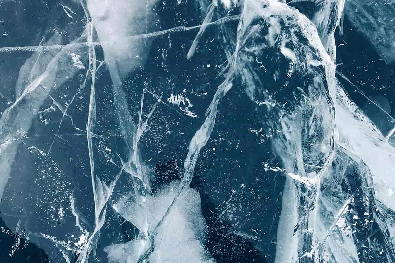 Cracks running through a sheet of blue ice