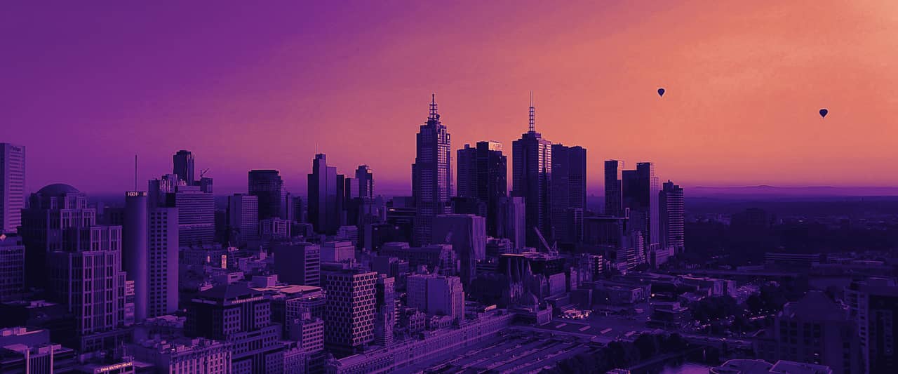 The Melbourne skyline at sunrise with hot air balloons in the sky