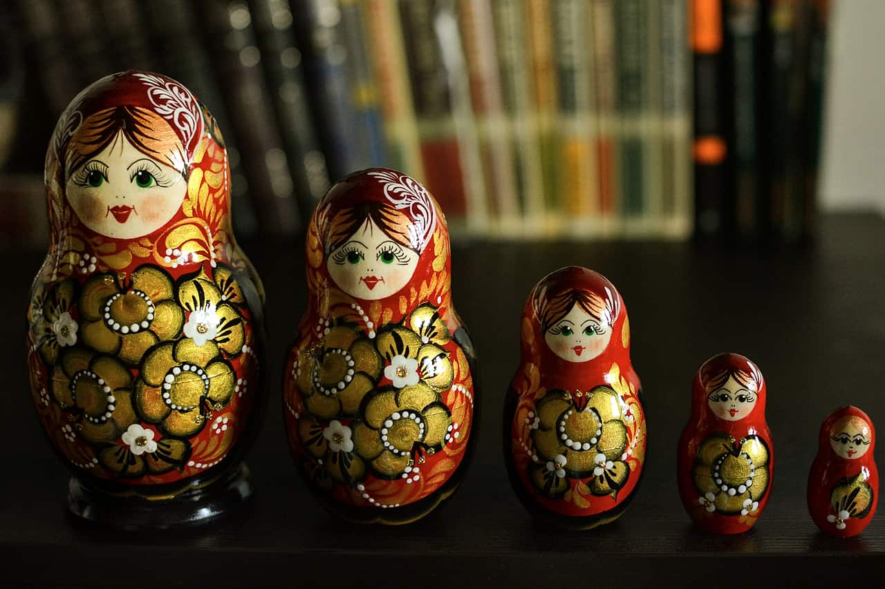 A set of painted Russian nesting dolls in a row on a table